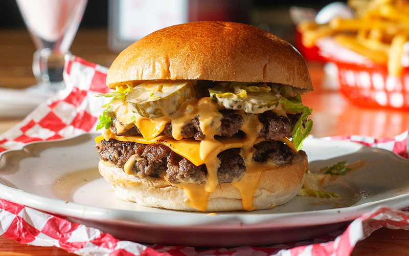 double burger on checked tablecloth