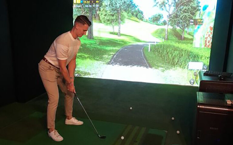 man playing virtual golf at vgolf brighton